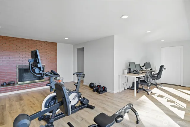 a view of a workspace with furniture and a window