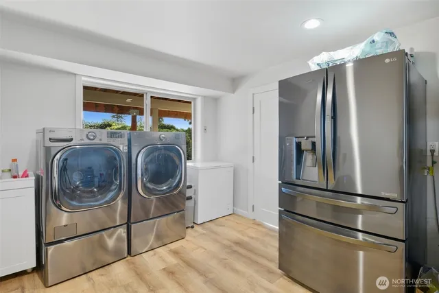 a kitchen with a refrigerator and washer