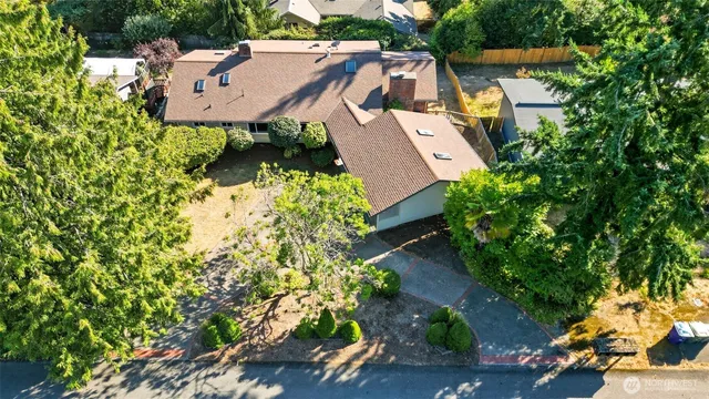 an aerial view of a house with a yard basket ball court and outdoor seating