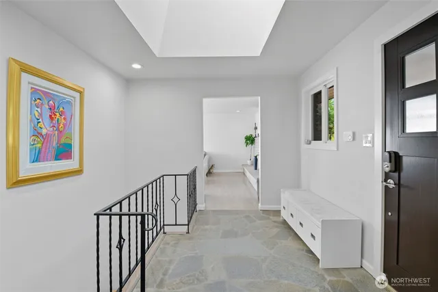 a view of hallway with window and stairs