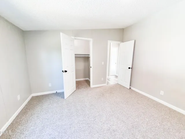 a view of a house with a yard and lake view
