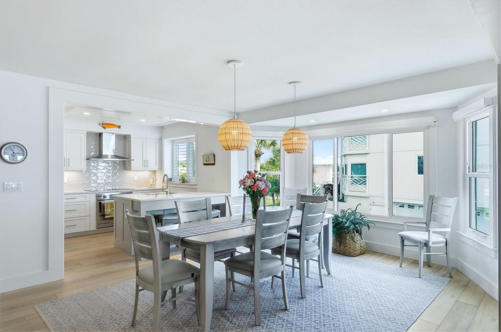 11000 Placida Road, Unit 2501 Placida, FL 33946 - Photo 12 of 56 a view of a dining room and livingroom with furniture wooden floor a chandelier