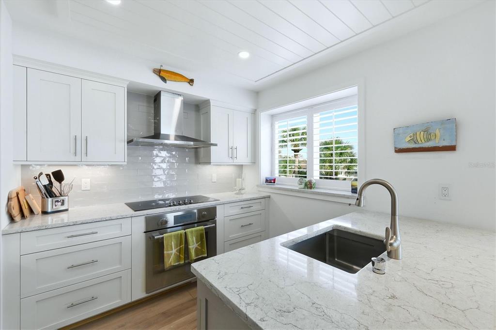 11000 Placida Road, Unit 2501 Placida, FL 33946 - Photo 15 of 56 a kitchen with granite countertop a sink and a stove top oven