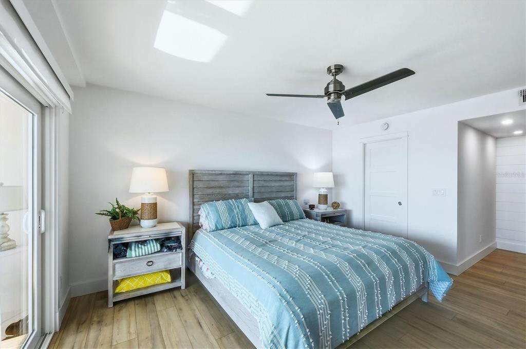 11000 Placida Road, Unit 2501 Placida, FL 33946 - Photo 18 of 56 a bedroom with a bed and wooden floor