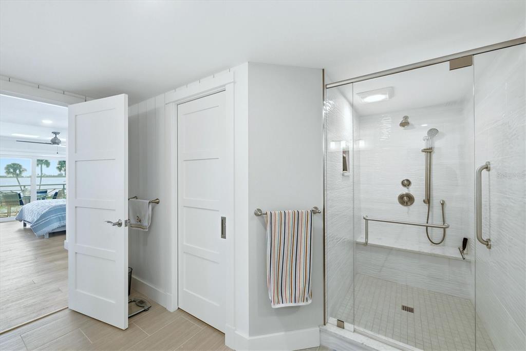 11000 Placida Road, Unit 2501 Placida, FL 33946 - Photo 20 of 56 a bathroom with a glass shower door and a sink