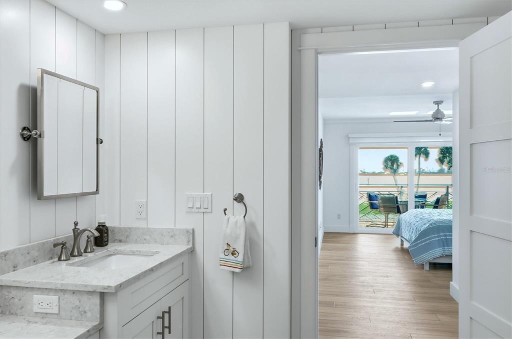 11000 Placida Road, Unit 2501 Placida, FL 33946 - Photo 21 of 56 a en suite bathroom with a sink a large mirror and shower