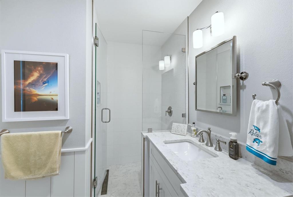 11000 Placida Road, Unit 2501 Placida, FL 33946 - Photo 25 of 56 a bathroom with a granite countertop sink mirror and vanity