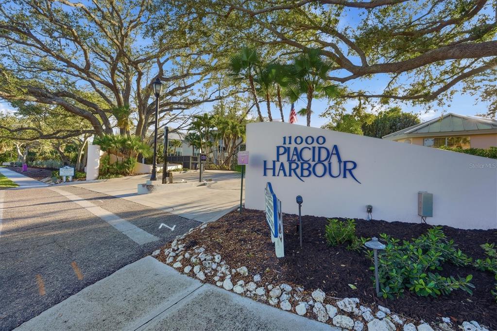 11000 Placida Road, Unit 2501 Placida, FL 33946 - Photo 31 of 56 a sign board with buildings in the background
