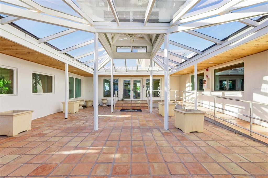 11000 Placida Road, Unit 2501 Placida, FL 33946 - Photo 37 of 56 a view of a patio with table and chairs and a barbeque