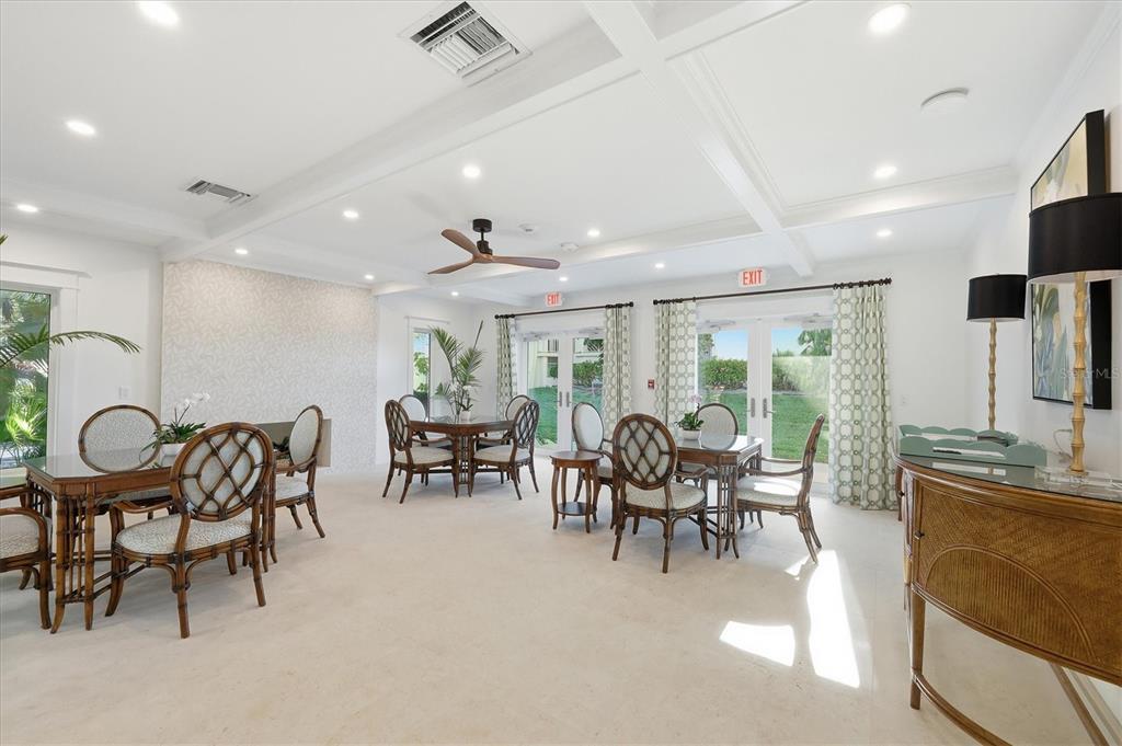 11000 Placida Road, Unit 2501 Placida, FL 33946 - Photo 39 of 56 a view of a dining room and livingroom with furniture a rug a fireplace and a chandelier