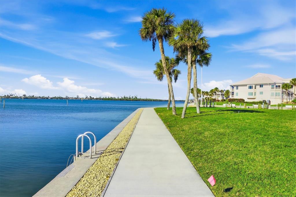 11000 Placida Road, Unit 2501 Placida, FL 33946 - Photo 49 of 56 a view of a lake with a garden