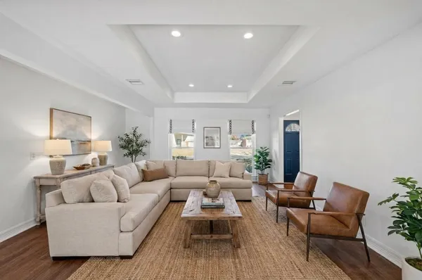 a living room with furniture and wooden floor