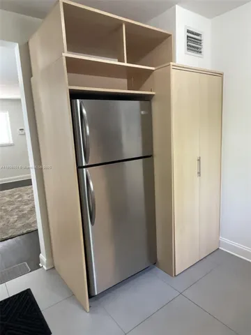 a view of a refrigerator in kitchen and wooden floor