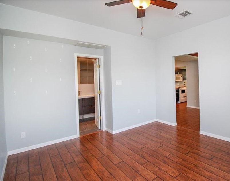 2612 San Pedro Street, Unit 116 Austin, TX 78705 - Photo 12 of 20 wooden floor in an empty room with a window