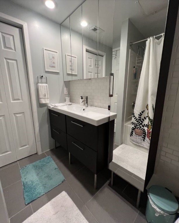 2612 San Pedro Street, Unit 116 Austin, TX 78705 - Photo 15 of 20 a bathroom with a sink a toilet and a mirror