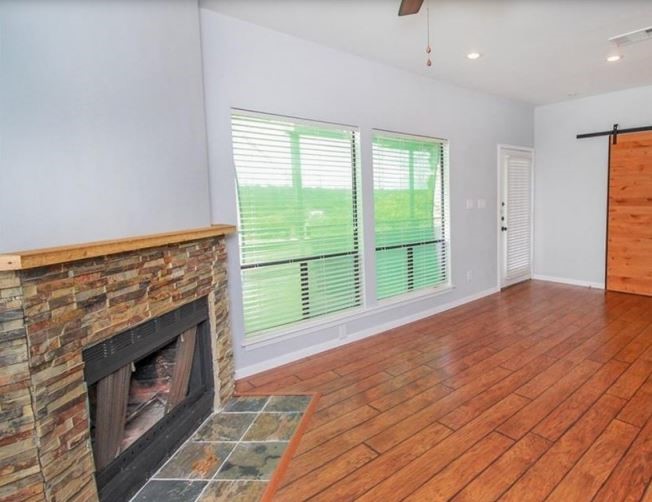 2612 San Pedro Street, Unit 116 Austin, TX 78705 - Photo 5 of 20 a view of an empty room with a fireplace and a window