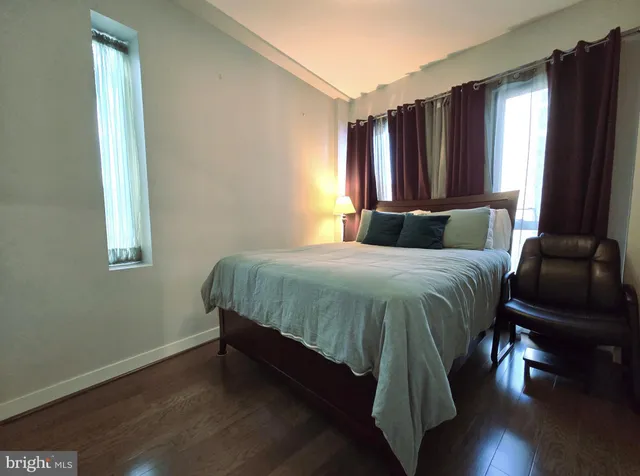 a bedroom with a bed and a mirror