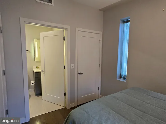 a view of a hallway with closet and wooden floor