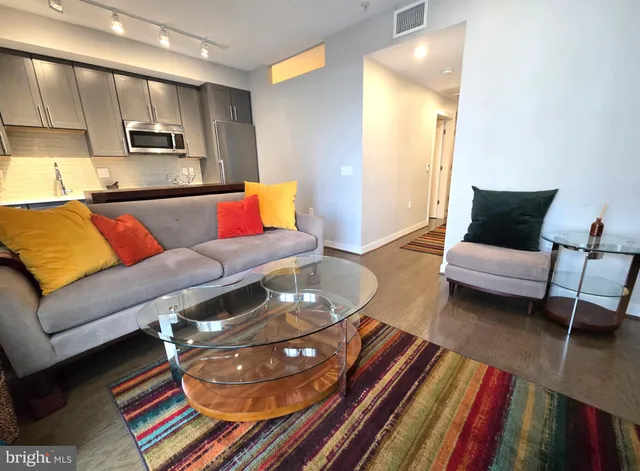 a living room with furniture and a rug