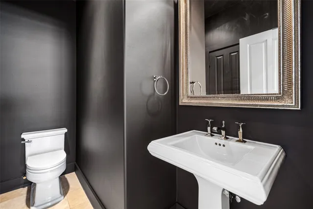 a bathroom with a sink toilet and mirror
