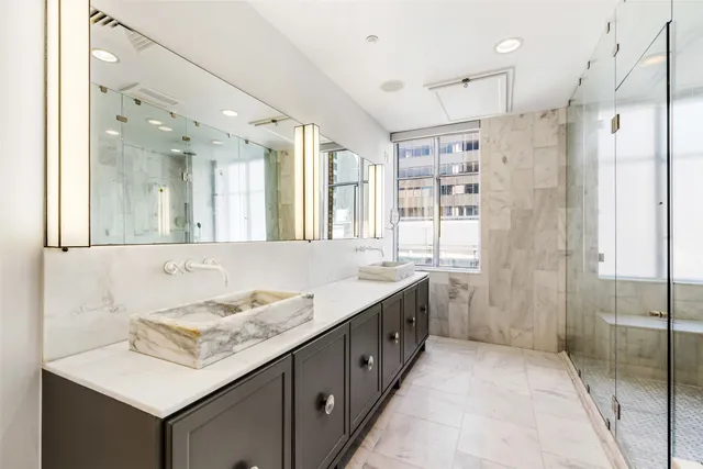 a bathroom with a granite countertop sink mirror and double