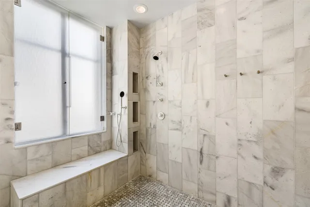 a bathroom with a shower and a tub