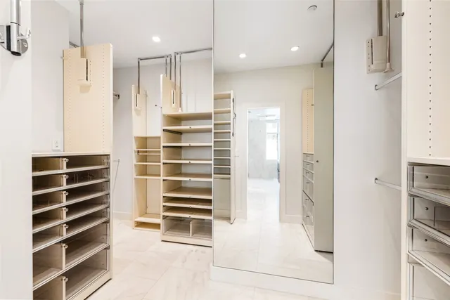 a view of walk in closet and kitchen with window