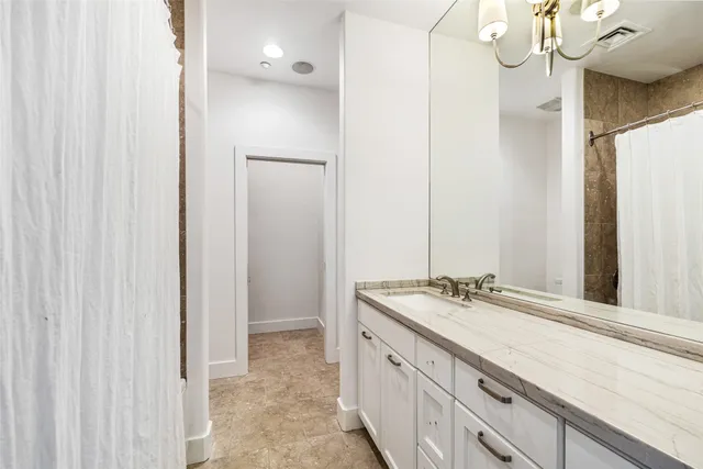 a bathroom with a double vanity sink and a mirror