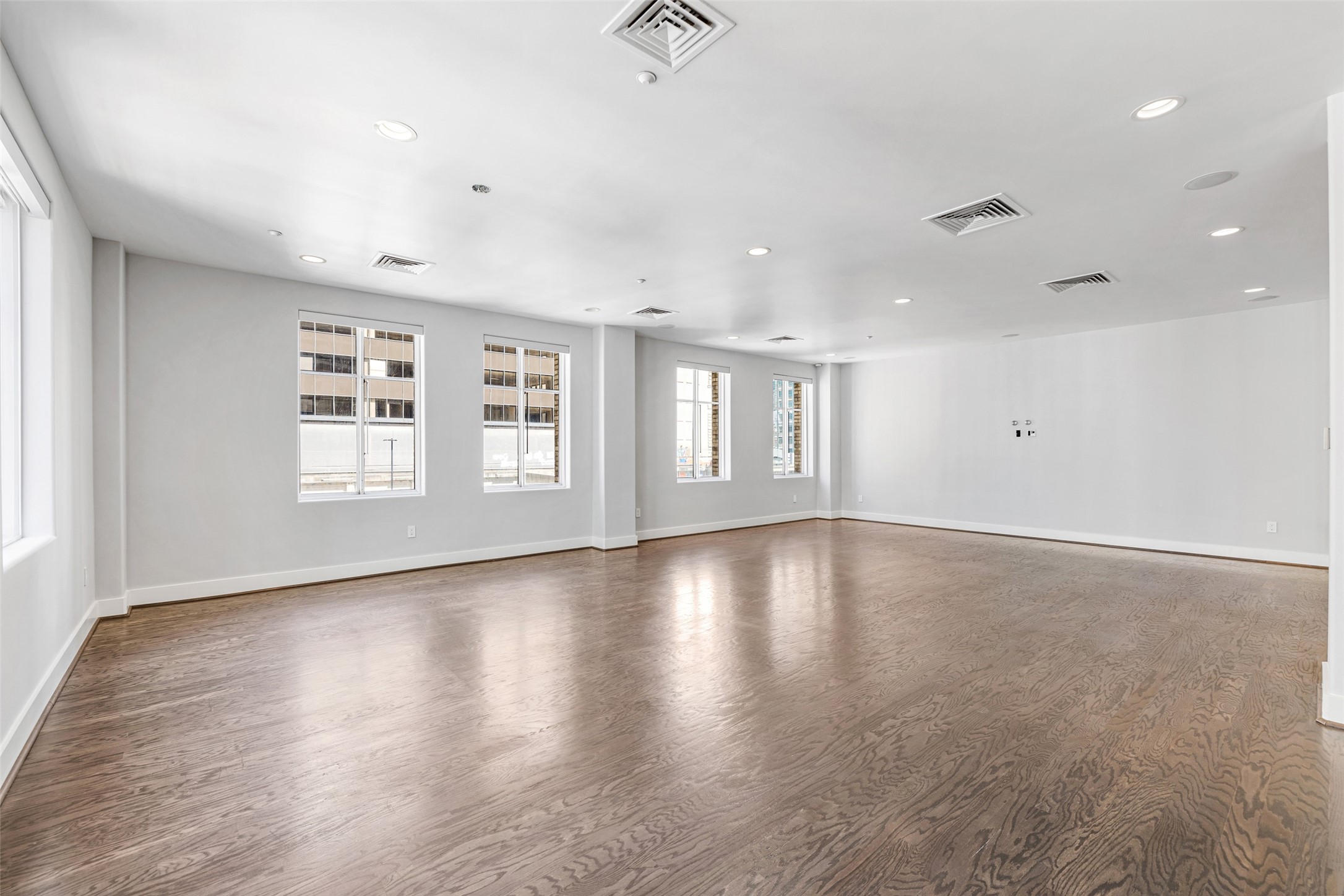 914 Main Street, Unit 1201 Houston, TX 77002 - Photo 10 of 36 a view of an empty room with wooden floor and a window