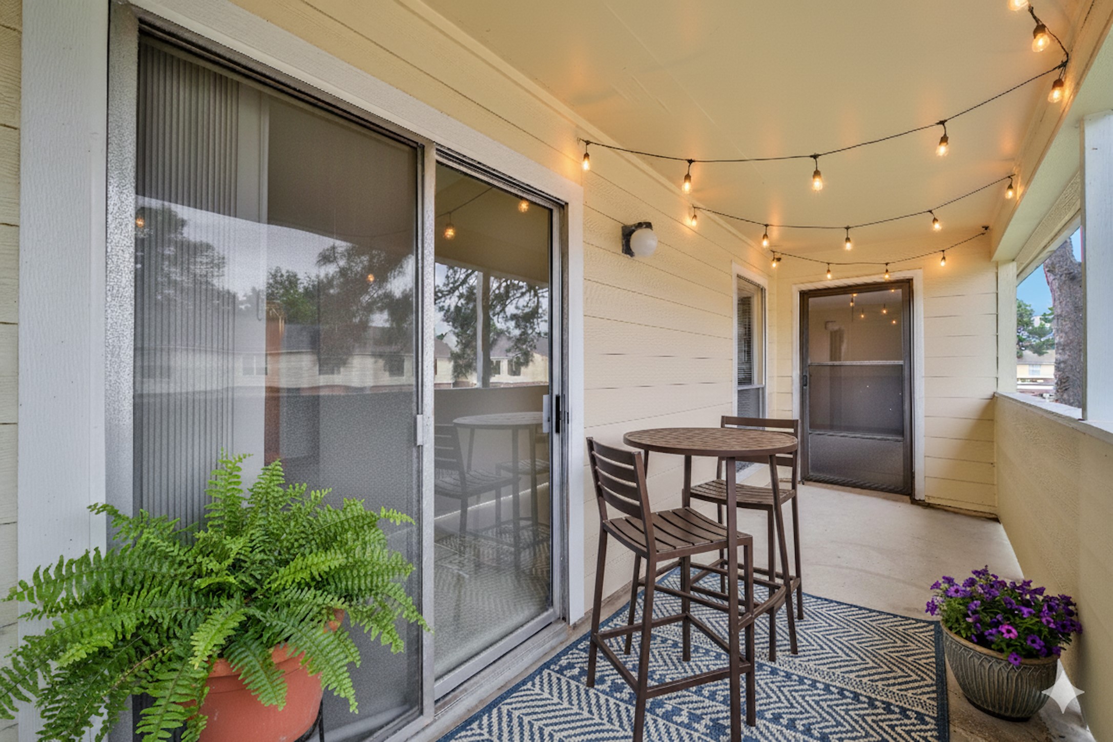 a view of a chairs and table in a patio