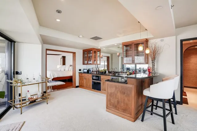 a kitchen with sink and chairs