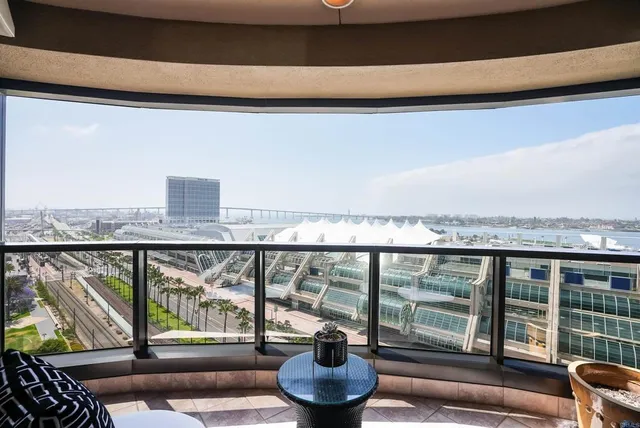 a living room with furniture and a floor to ceiling window