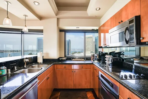 a kitchen with stainless steel appliances a sink a stove and a counter space