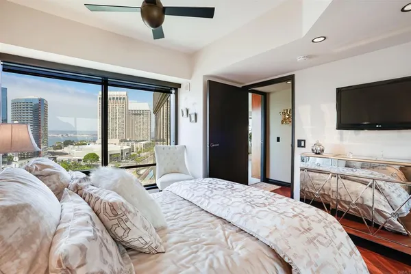 a bedroom with a large bed and a flat screen tv