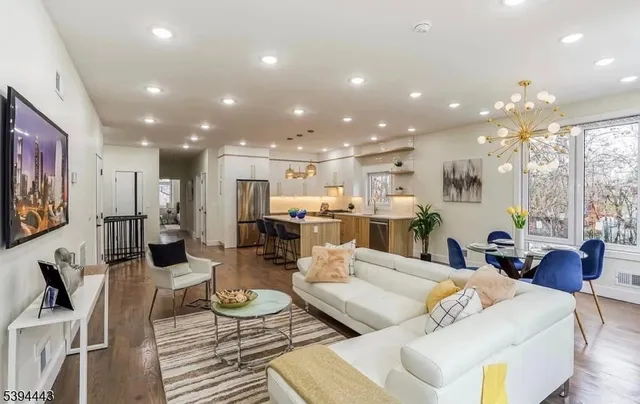 a living room with furniture and a view of kitchen