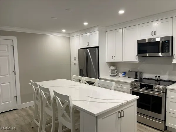 a kitchen with a sink stove and microwave