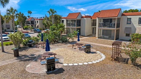 a view of a patio with a table and chairs under an umbrella