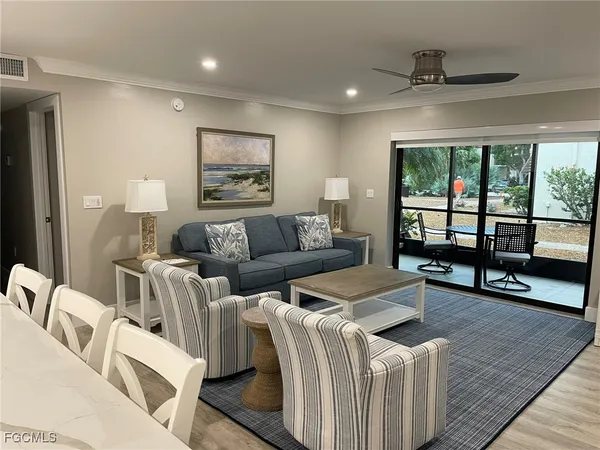 a living room with furniture and a painting