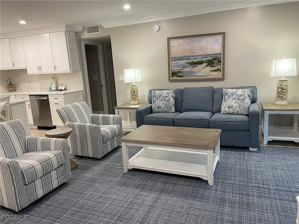 a living room with a flat screen tv and a dresser
