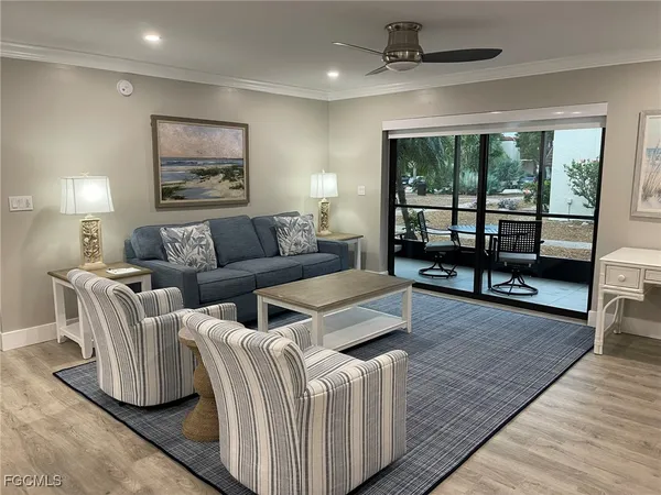 a view of a room with furniture and window