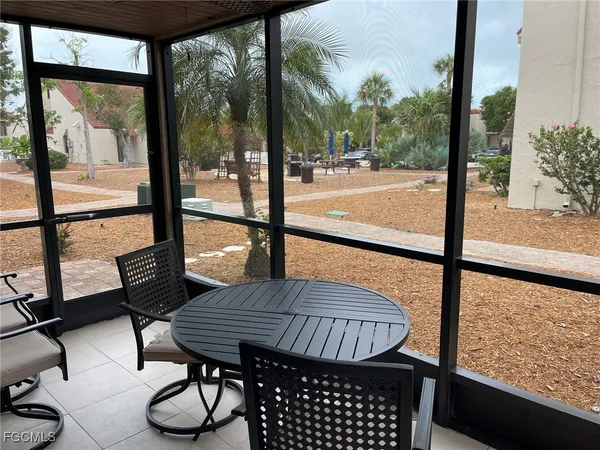 a living room with furniture and a view of kitchen