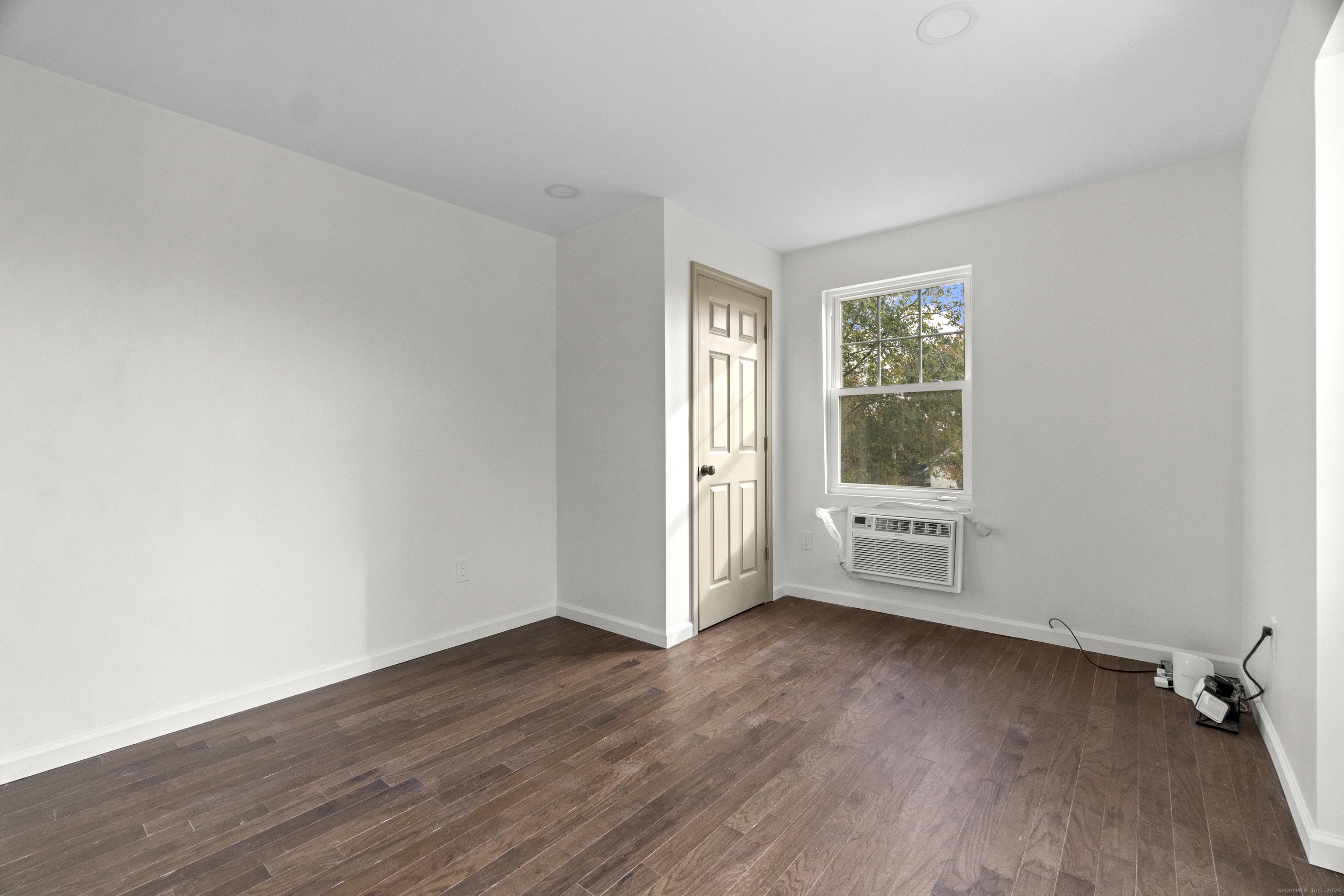 1285 Townsend Avenue, Unit 1 New Haven, CT 06513 - Photo 13 of 17 an empty room with wooden floor and windows