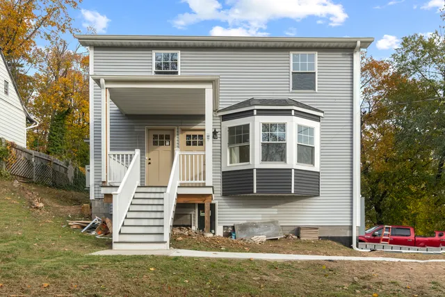 a front view of a house with a yard and garage