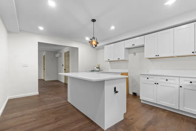 a kitchen with cabinets wooden floor and a sink