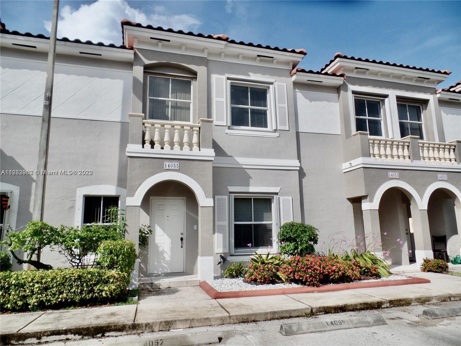 14055 Southwest 49th Street, Unit 6 Miramar, FL 33027 - Photo 1 of 12 a front view of a house with a garden