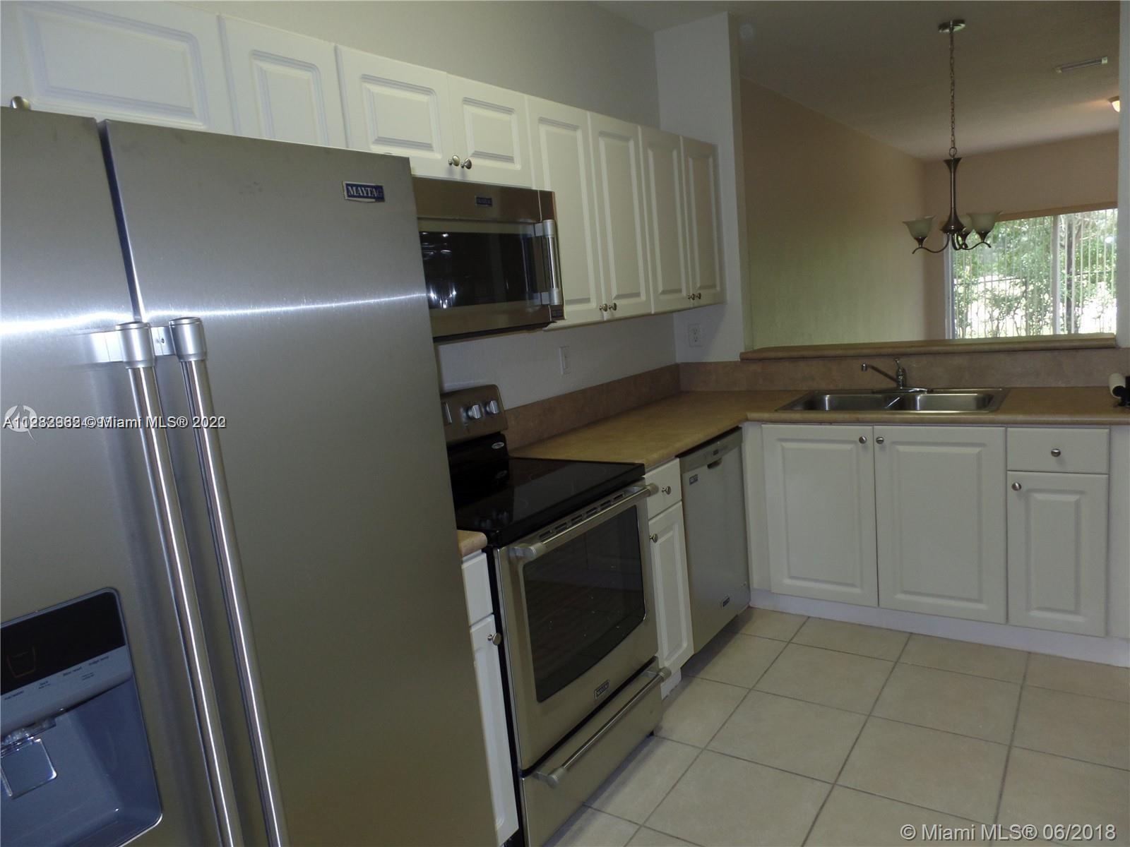 14055 Southwest 49th Street, Unit 6 Miramar, FL 33027 - Photo 2 of 12 a kitchen with a sink stove and microwave