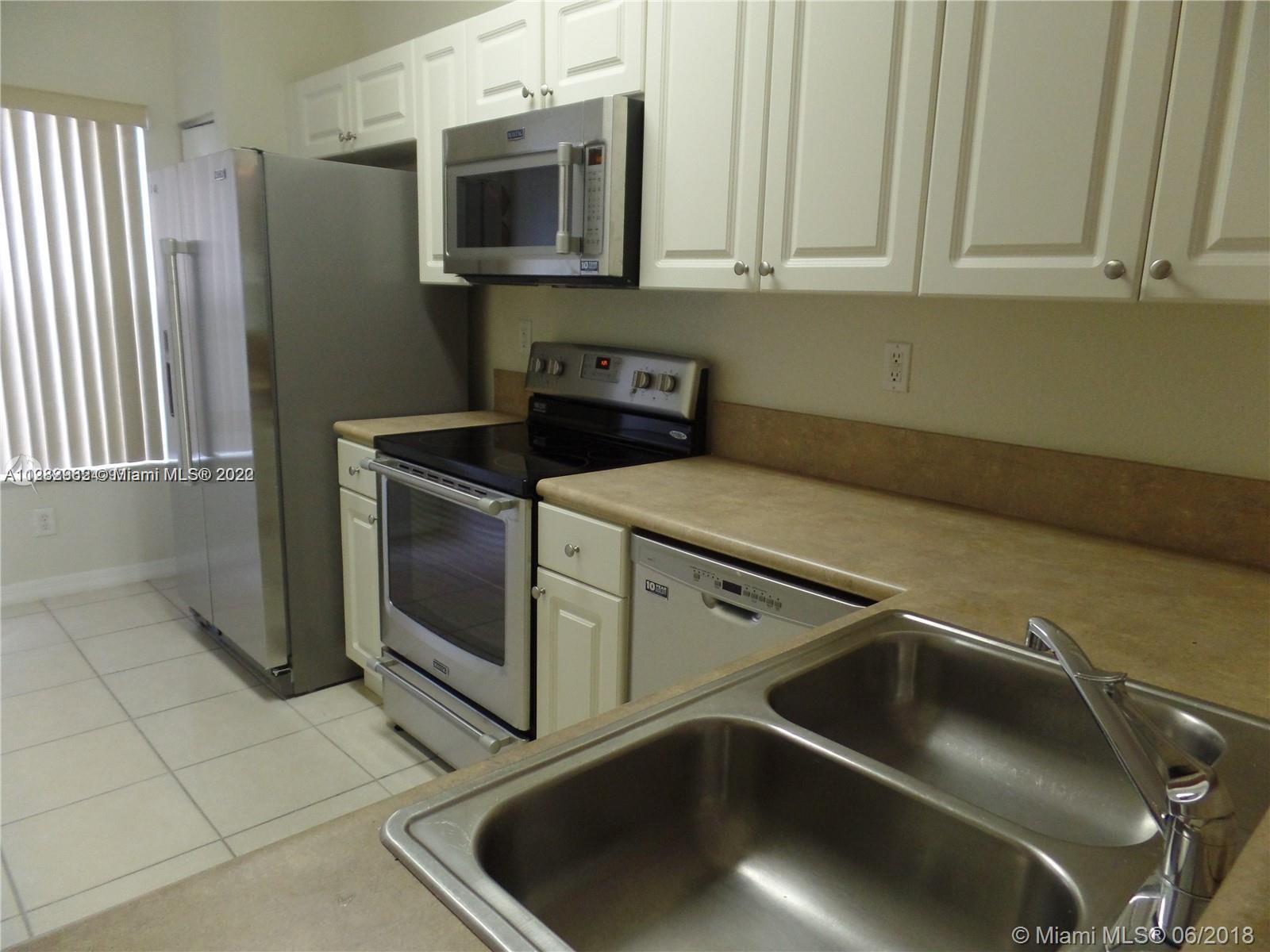 14055 Southwest 49th Street, Unit 6 Miramar, FL 33027 - Photo 3 of 12 a kitchen with a sink and cabinets