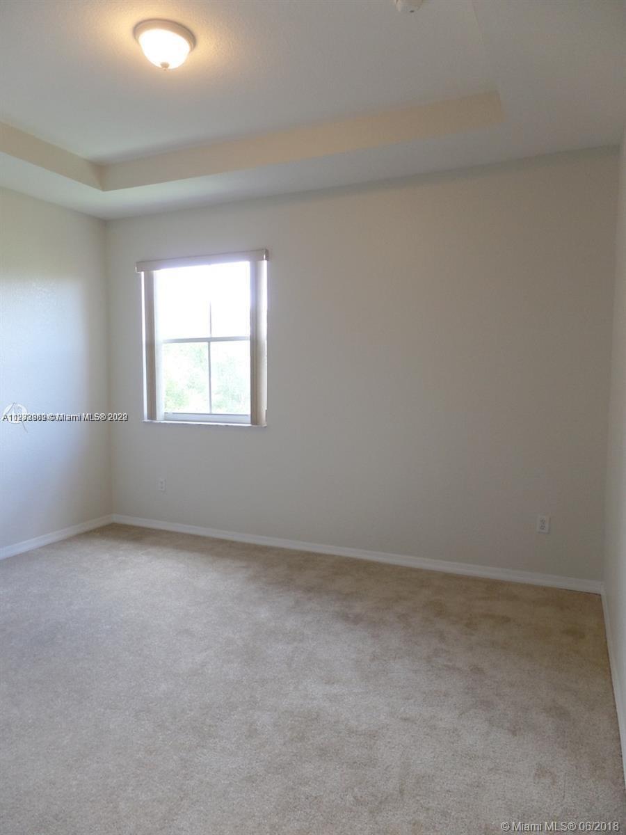14055 Southwest 49th Street, Unit 6 Miramar, FL 33027 - Photo 5 of 12 an empty room with windows