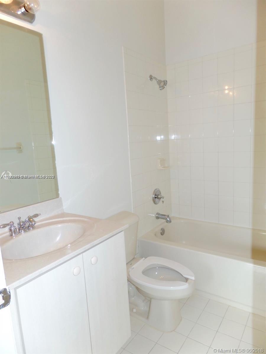 14055 Southwest 49th Street, Unit 6 Miramar, FL 33027 - Photo 6 of 12 a bathroom with a sink a toilet and shower