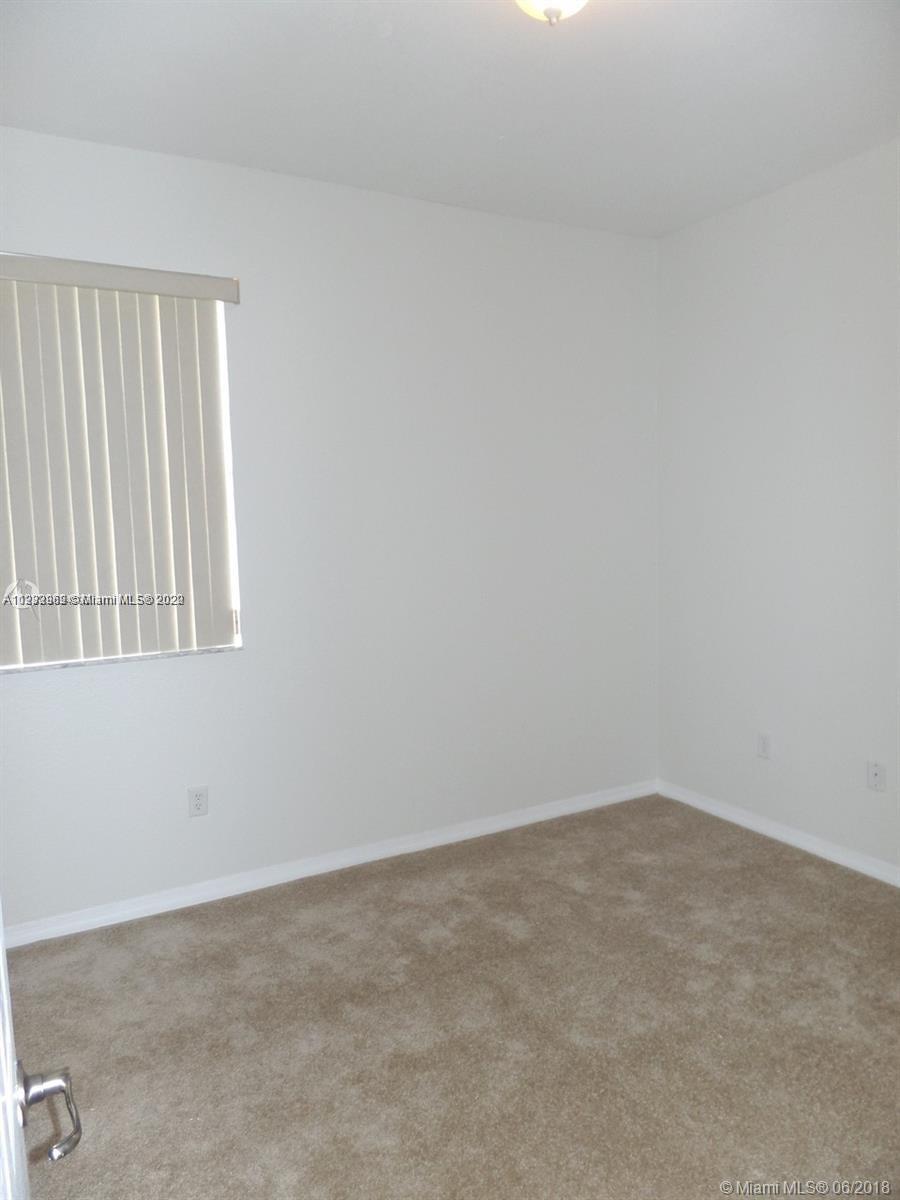 14055 Southwest 49th Street, Unit 6 Miramar, FL 33027 - Photo 7 of 12 an empty room with windows